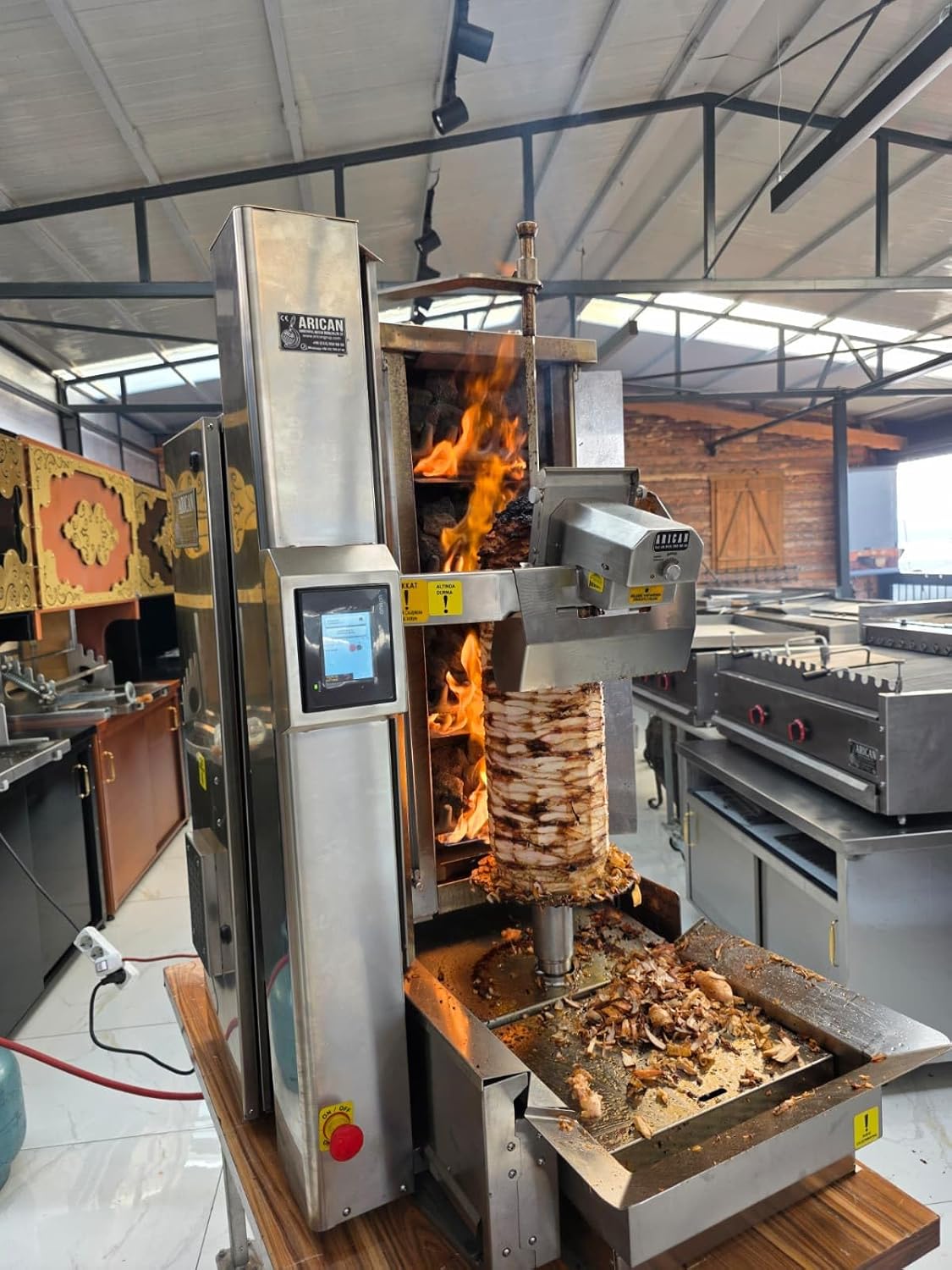 The Arican Robot in action during a simulated lunch rush, showing consistent meat slicing and holding on the heated bain-marie, demonstrating real-world performance.