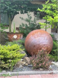 Image 1 of rusty metal garden sphere worth it